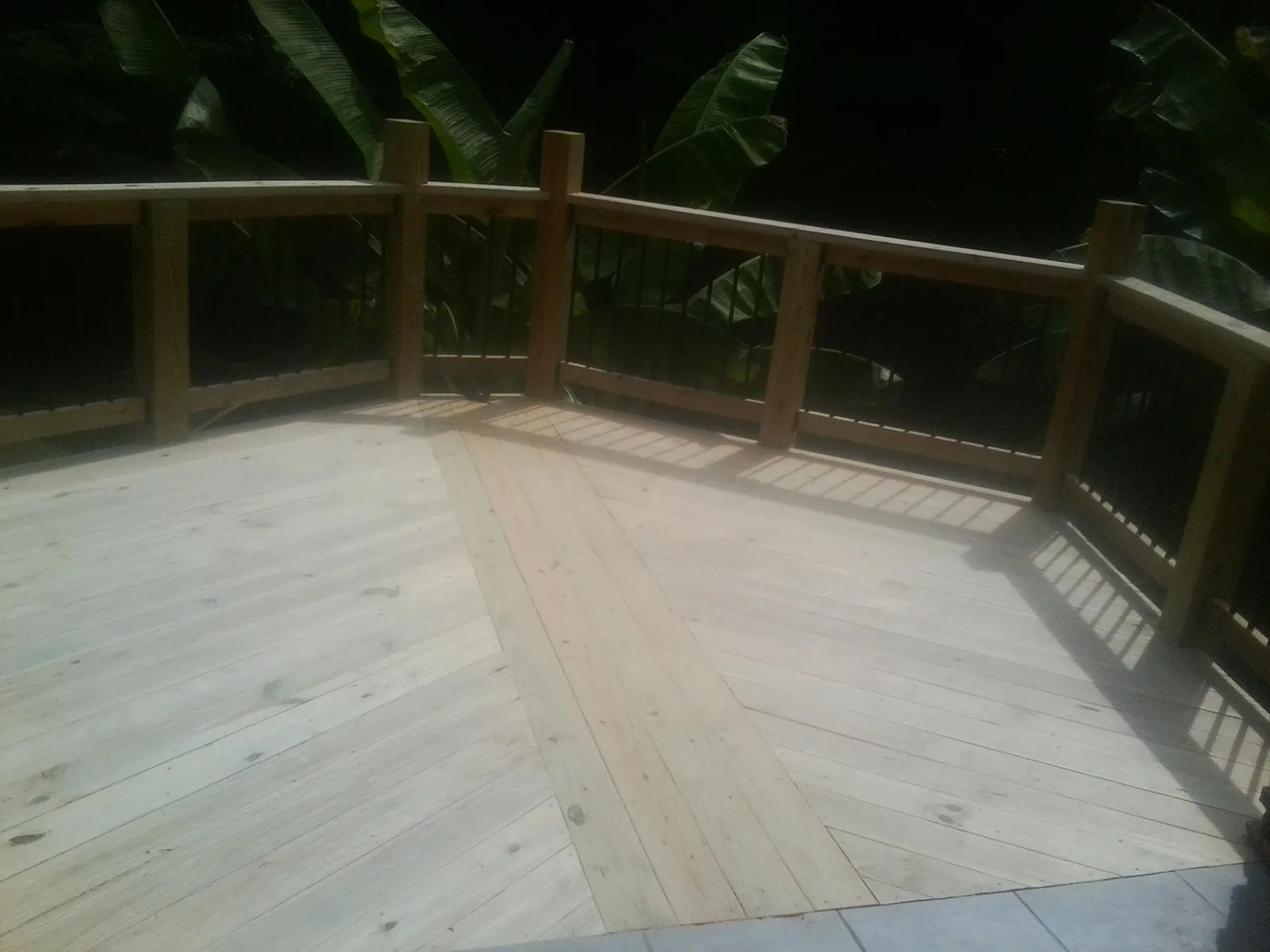 New wood deck and railing built off the back of a home in South Woodstock