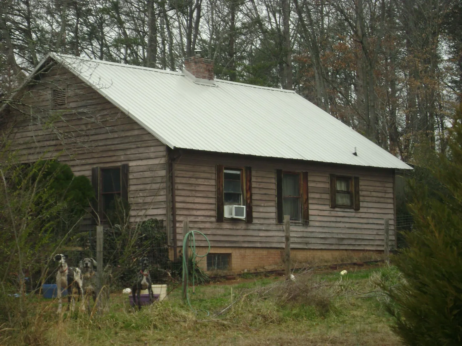 White metal roof on an old wood sided farmhouse, from a Asphalt Shingle Roof Repair job in South Woodstock